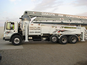 A Dakota RM Construction concrete pumping truck